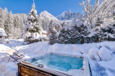 You can relax in beautiful surroundings in the hot-tub at Chalet Black Stone