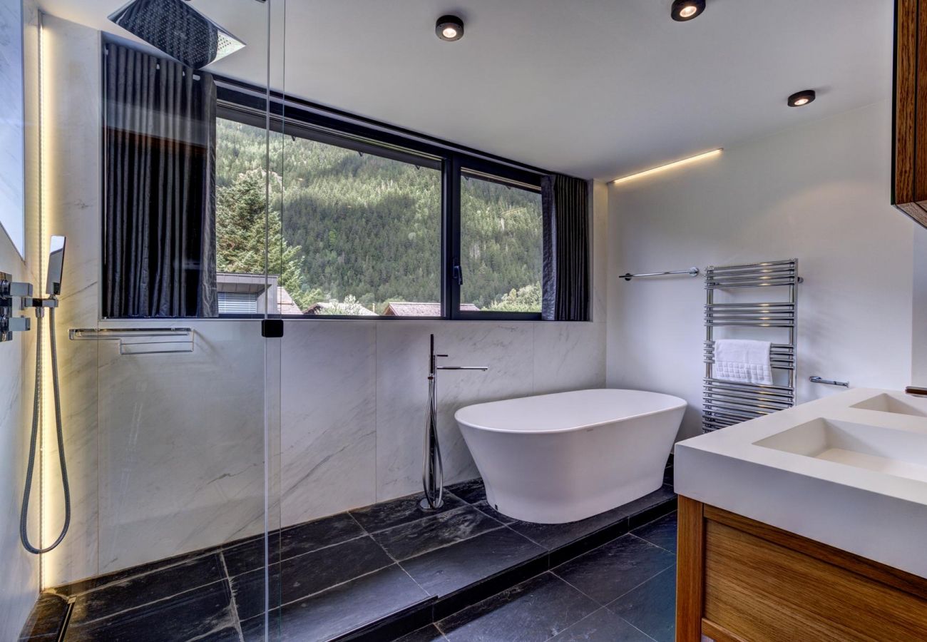 Bathroom of Bedroom 1 with stand-alone tub, separate shower and WC  Bedroom 1 of Chalet Black Pearl has a private bathroom with a stand-alone tub and a separate shower