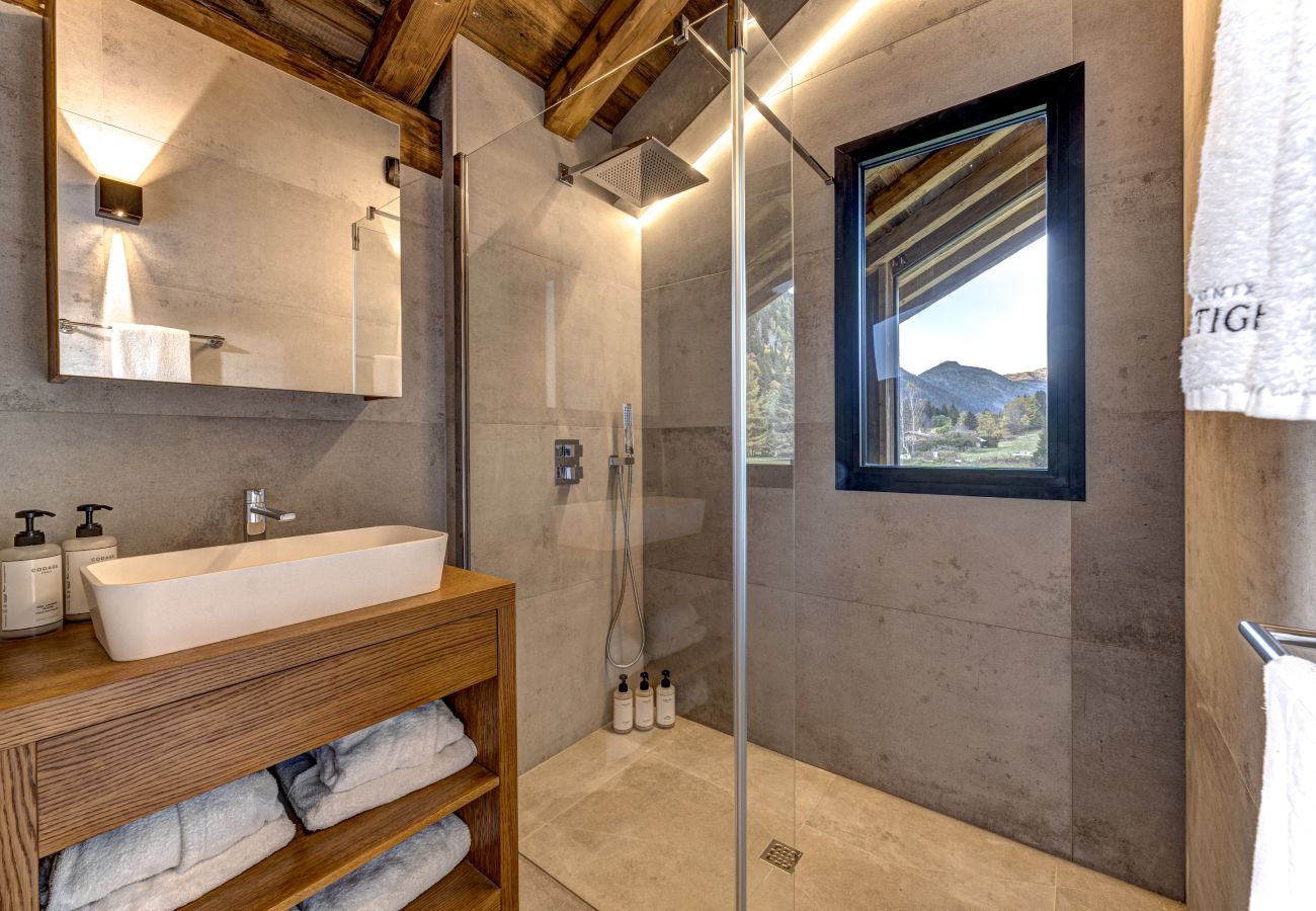 Bedroom 5, ensuite shower and basin with mountain views Bedroom 5 of Chalet les Côtés du Lavancher  has an ensuite shower and basin with mountain views.